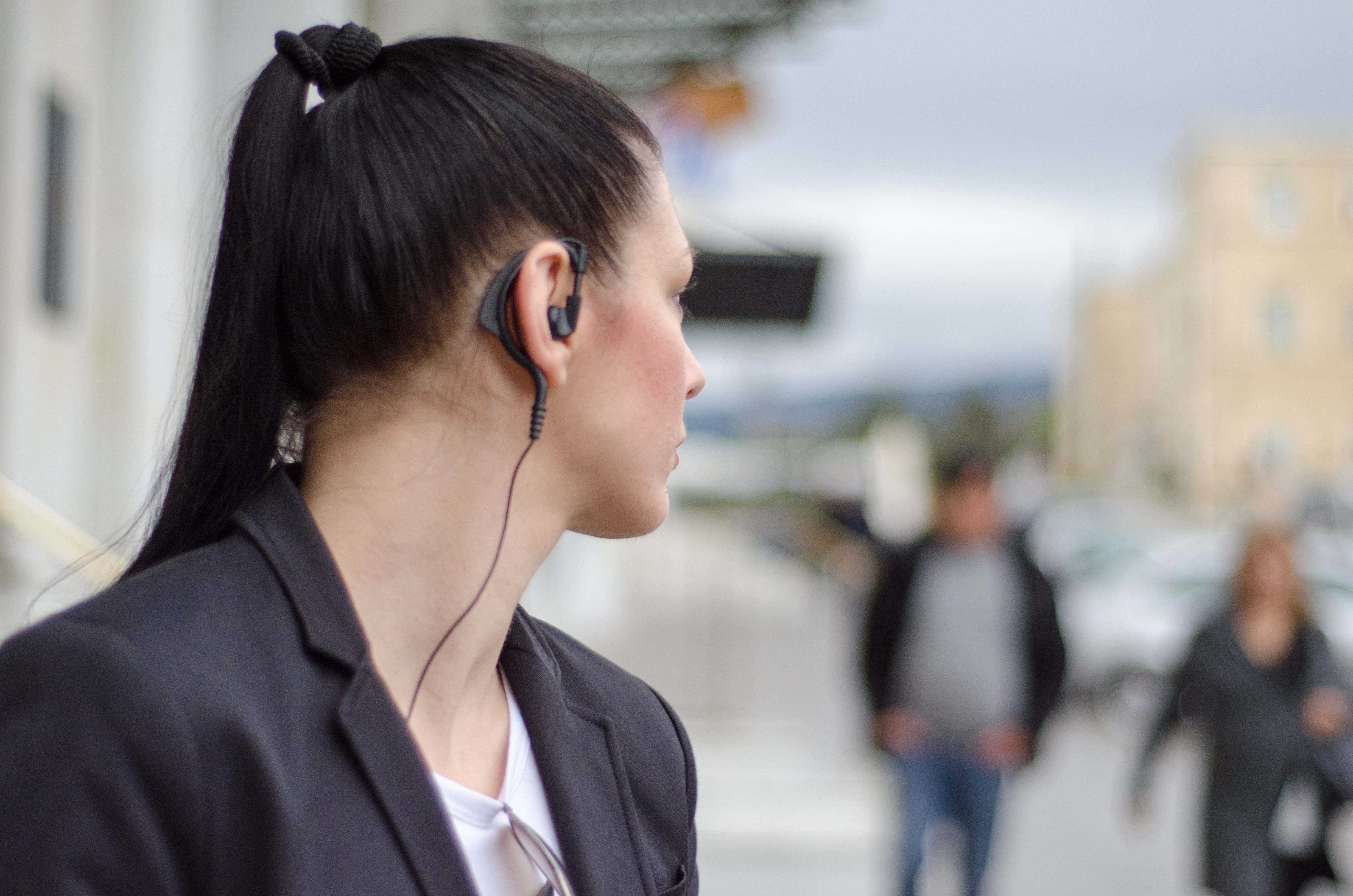 woman bodyguard with headset look at back